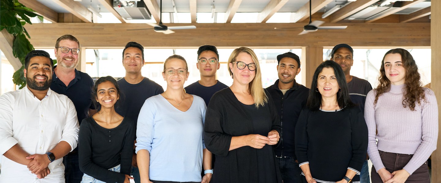 group photo of 11 smiling mentors and participants in the apple foundation program