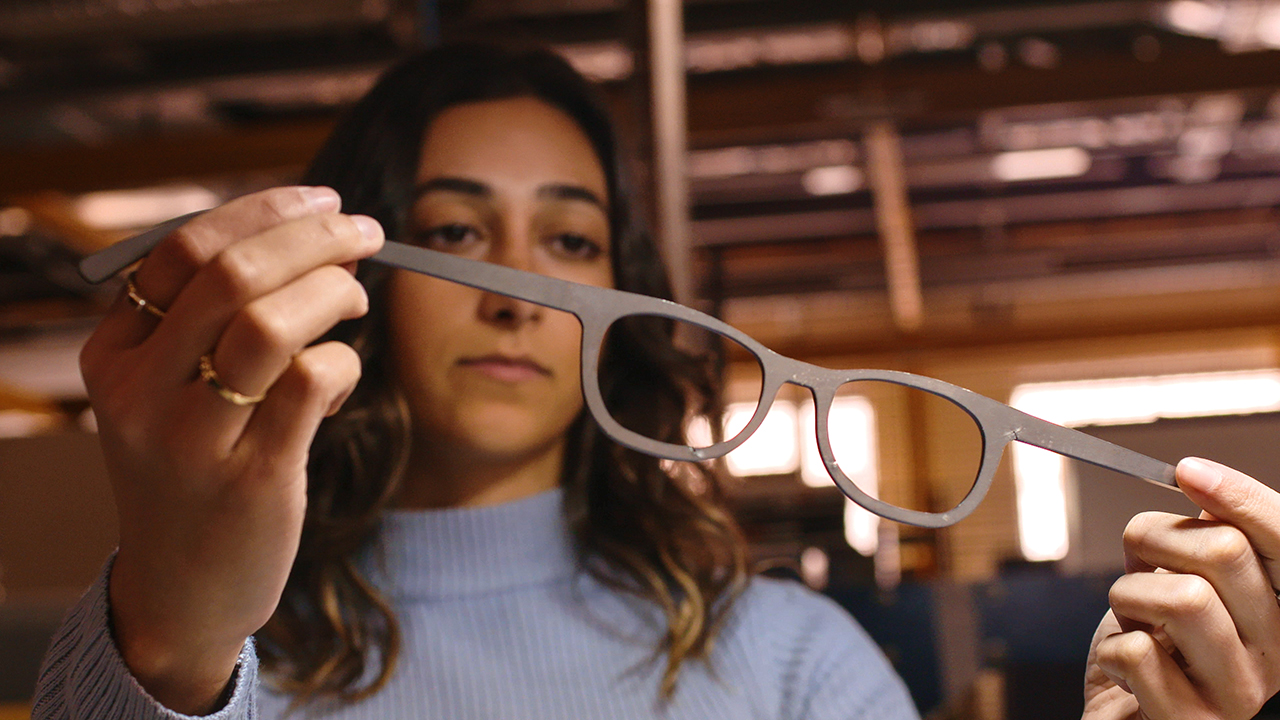 Female student holding glasses