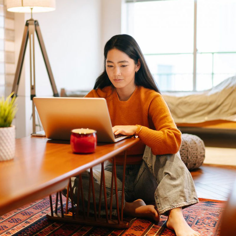 Student using laptop on coffee table