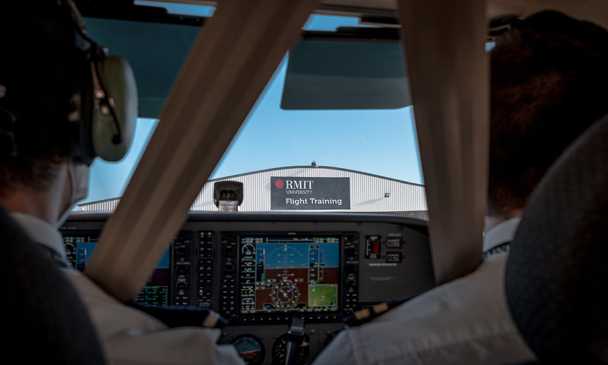 Two pilots looking out the front of a plane