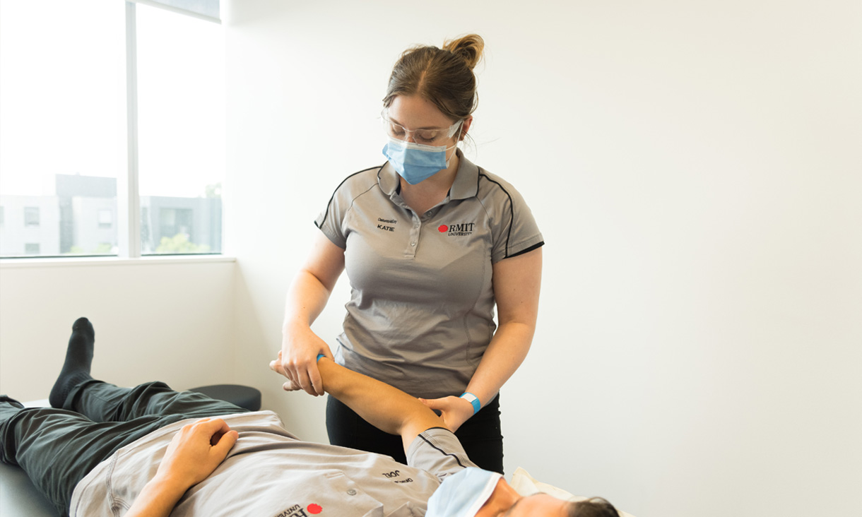 RMIT nursing student helping patient laying down