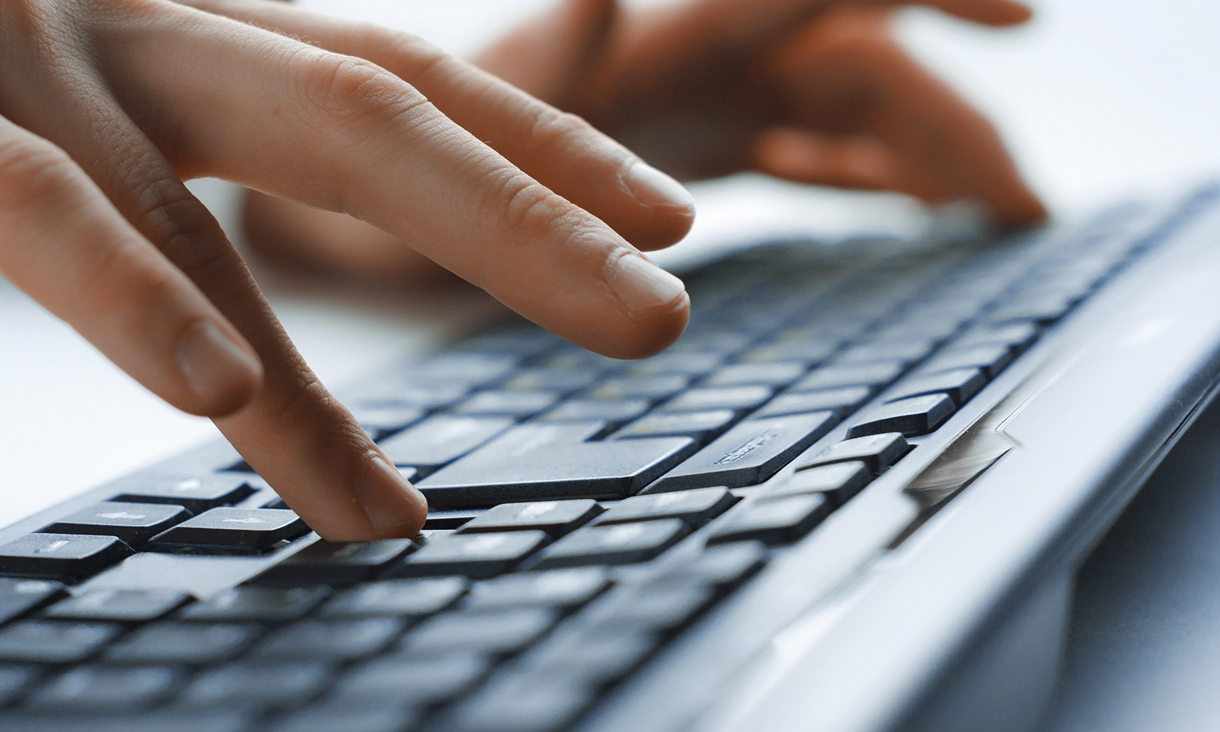 Hands typing on keyboard