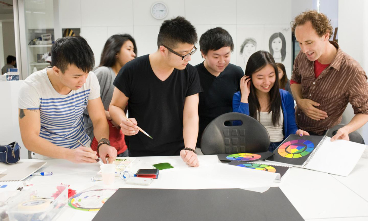 Tutor and students looking at colour wheel