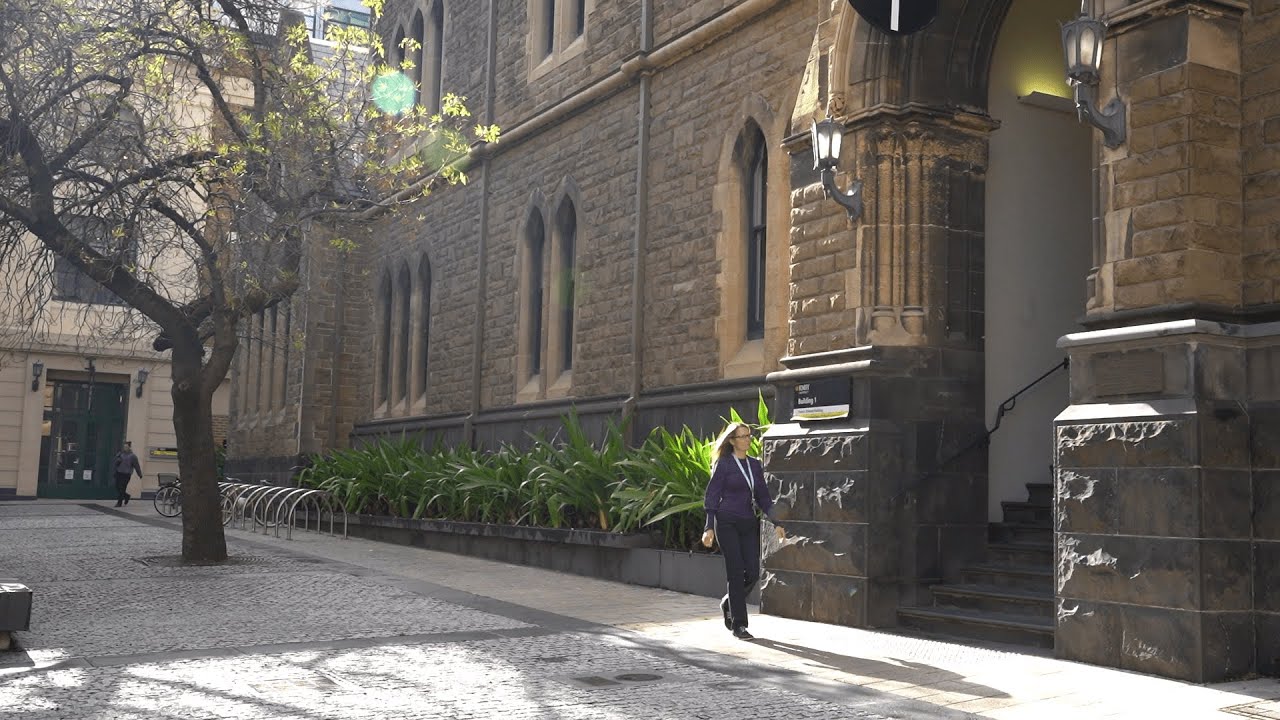 person walking near RMIT Building 1