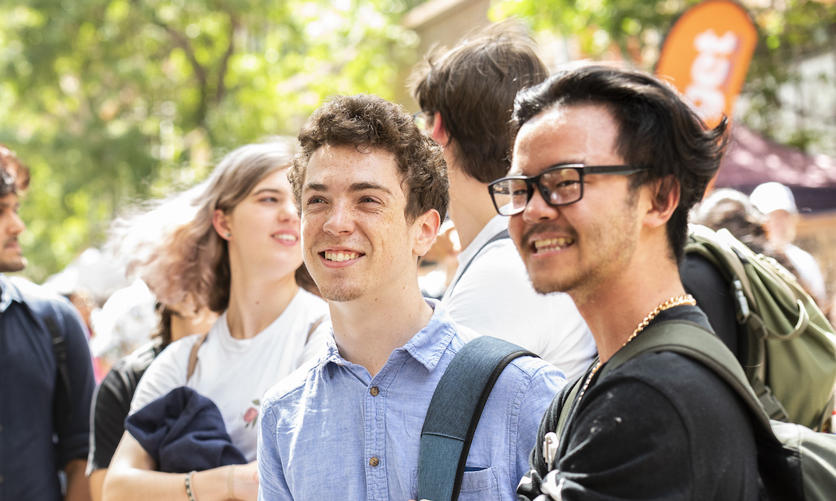 Two students smiling on campus.