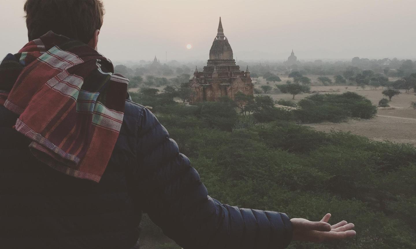 Student looking at temple in the distance.