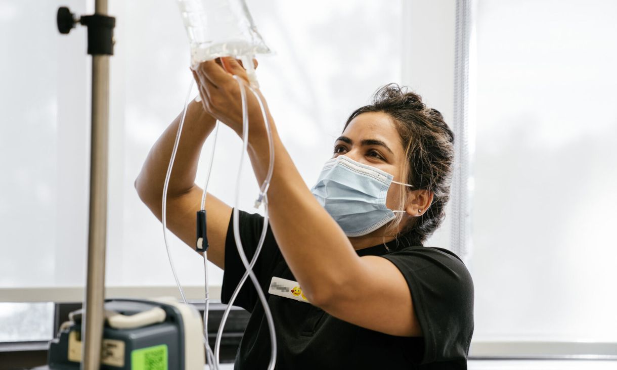 nurse handling an iv drip