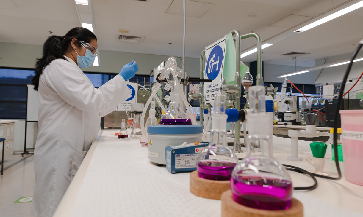 Science student standing in a chemistry lab