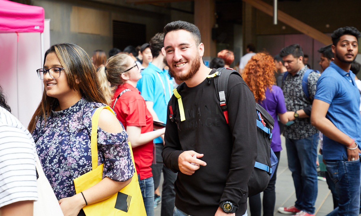 Student with backpack at City campus