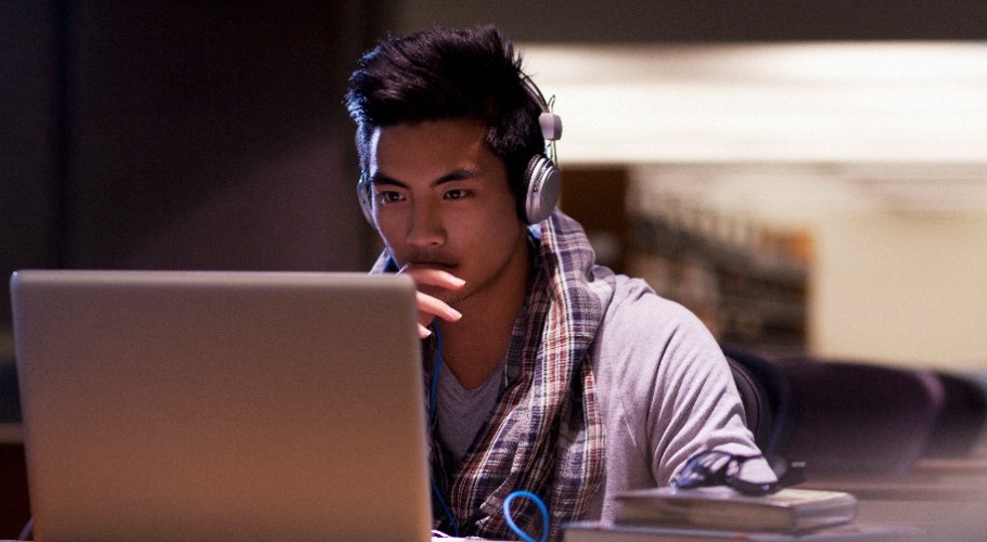 A student stares at a laptop. 