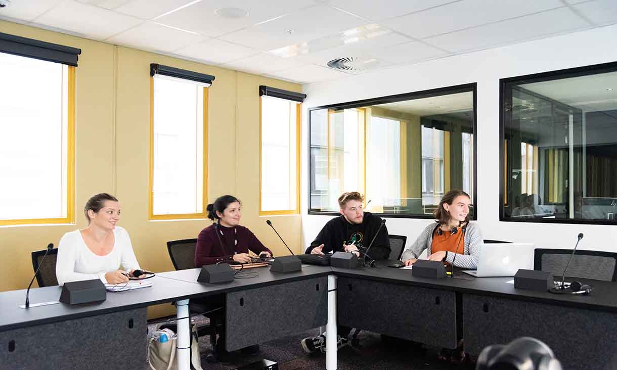 A panel is interviewed in a classroom setting.